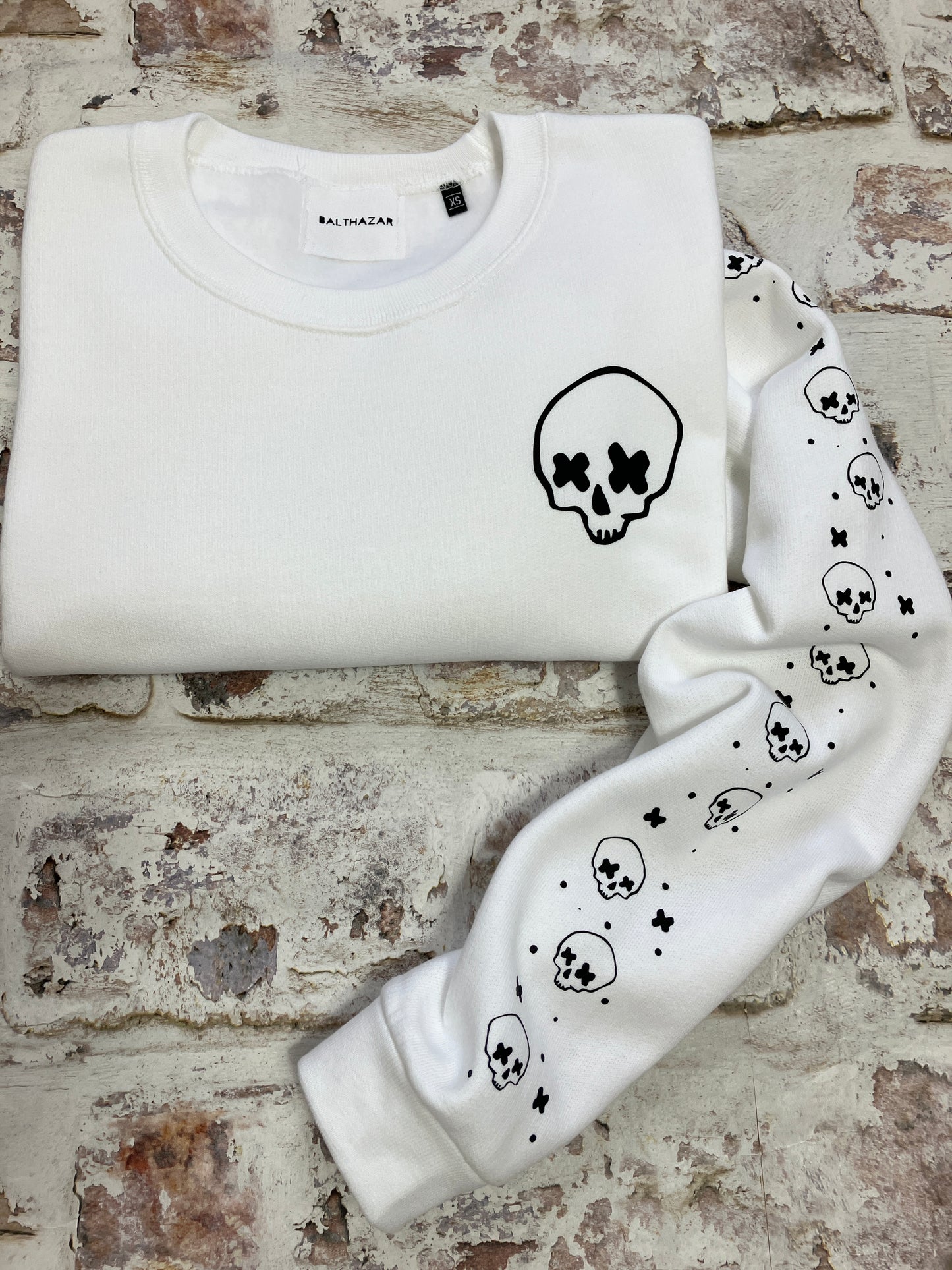 Cross eyed skull confetti sleeved sweatshirt
