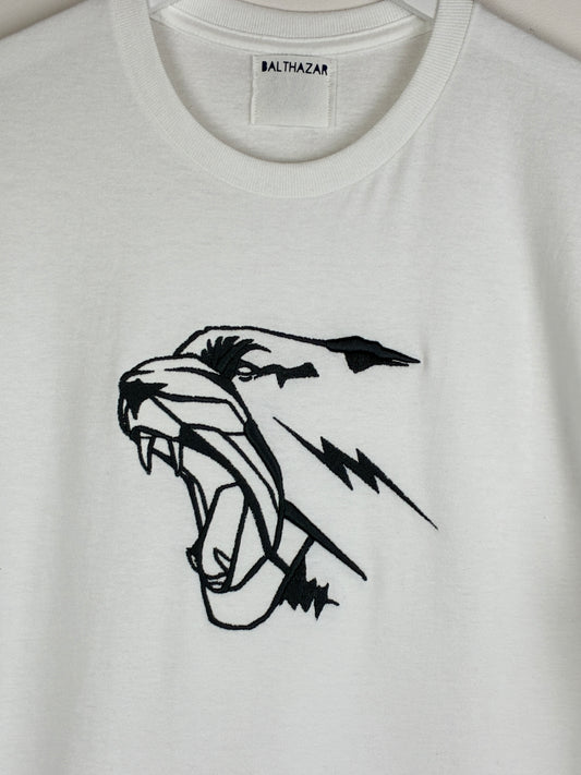 White t-shirt with an embroidered graphic style leopard head, measuring 7 inches in width by 6.5 inches in width and positioned in the centre of the chest. Statement style design that is customisable with your choice of embroidery thread.