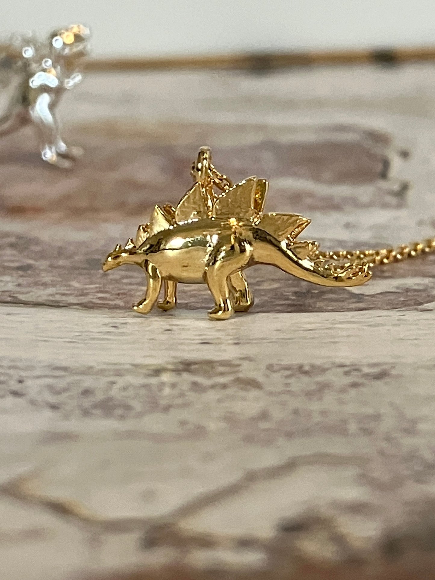 Gold Stegosaurus necklace - micro dinosaur jewellery
